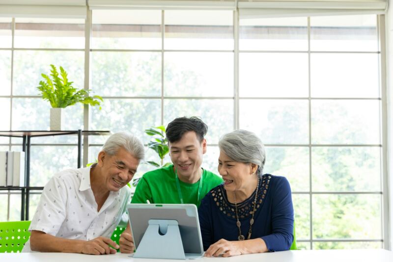 An advisor showing an older couple something on a tablet