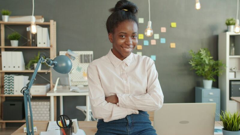 A smiling woman standing in a bright office